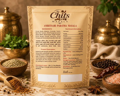 A standing product information card for Chuti's Masala Amritsari Paratha Masala, surrounded by spices, salt, and a wooden spoon in a warm, rustic setting.