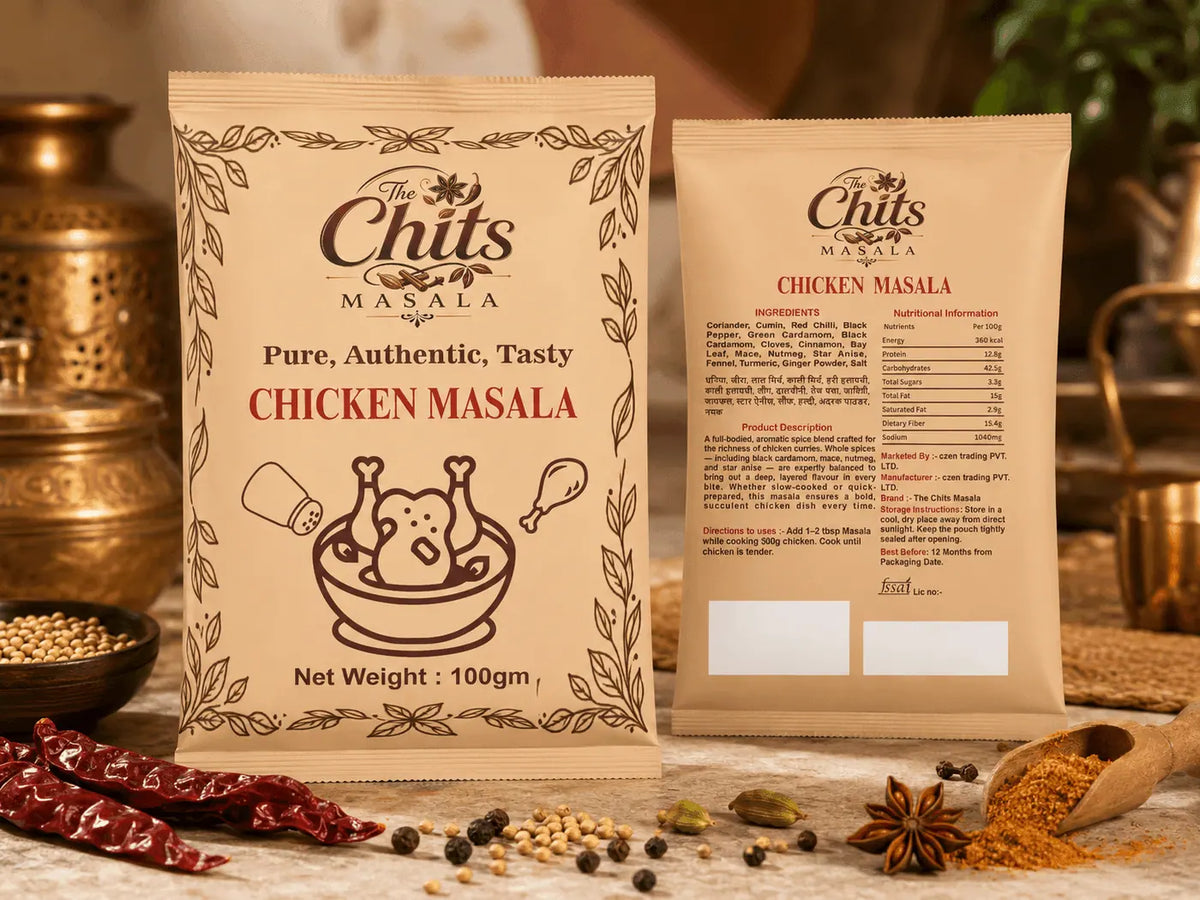 Two bags of Chits Masala Chicken Masala spice mix displayed on a rustic table with whole spices, dried red chilies, and brass utensils in the background.