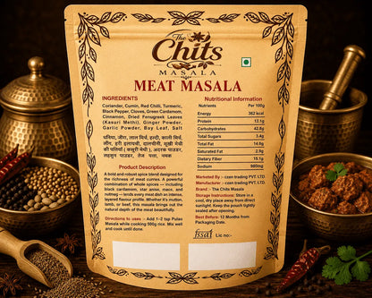 A stand-up pouch of The Chits Masala Meat Masala spices, shown against a styled background with brass utensils, red chilies, and whole spices. The front of the packaging features a decorative brown border and the product name 'MEAT MASALA' in bold letters.