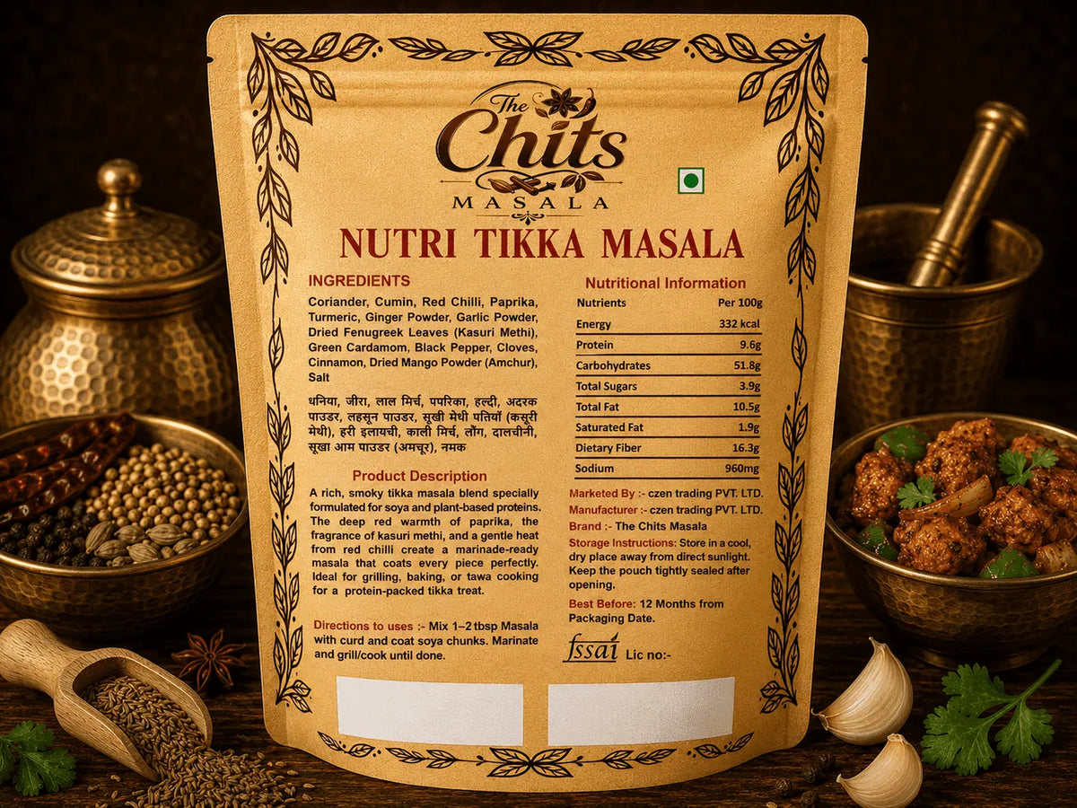 A stand-up pouch of The Chits Masala Nutri Tikka Masala seasoning mix, shown against a styled background with brass utensils, garlic, and herbs. The front of the package features a warm tan design with black text and decorative borders.