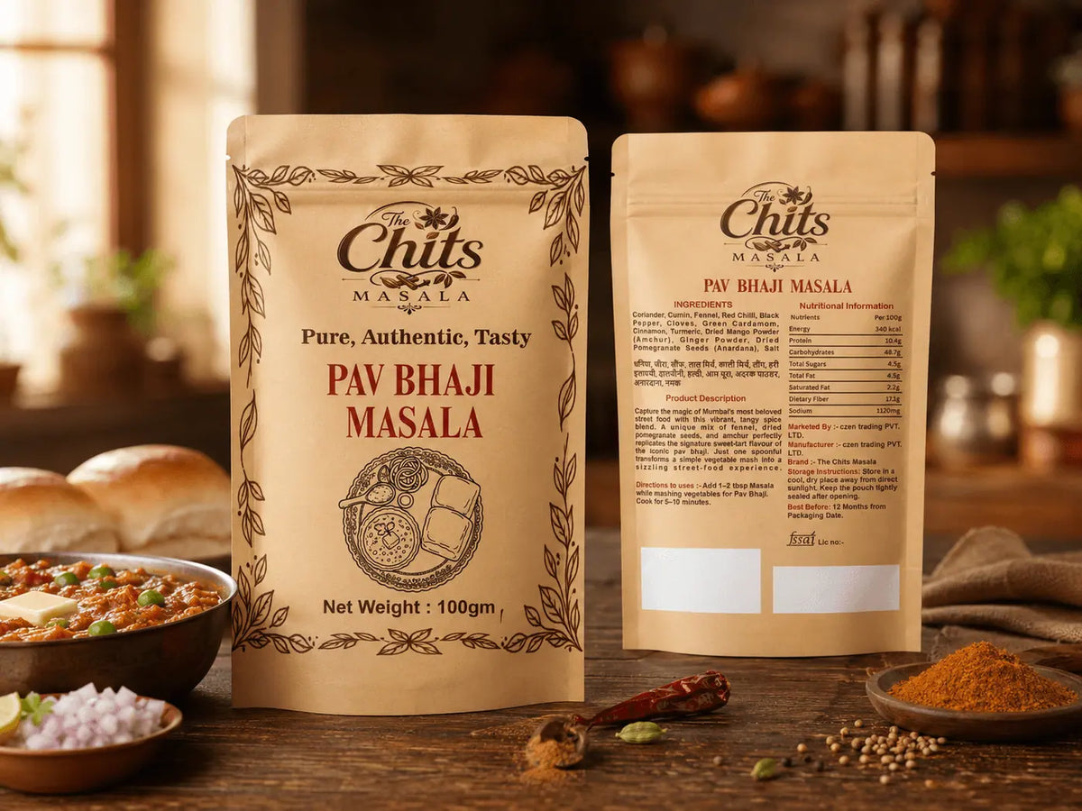 Two stand-up pouches of Chits Masala Pav Bhaji Masala seasoning displayed on a rustic wooden table with food props like bread, onions, and spices in a warm kitchen setting.