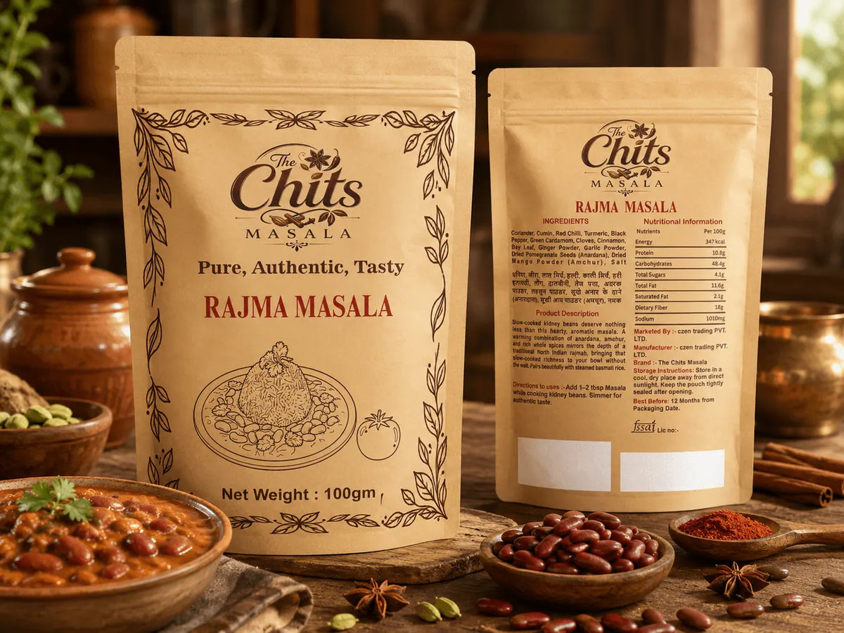 Two stand-up pouches of Chits Masala Rajma Masala seasoning displayed on a rustic wooden table with bowls of spices and food props in the background.