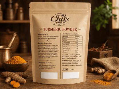 A stand-up kraft paper pouch of Chuts Masala Turmeric Powder on a rustic wooden surface, surrounded by loose turmeric roots, yellow turmeric powder, and burlap, with a softly blurred kitchen background.